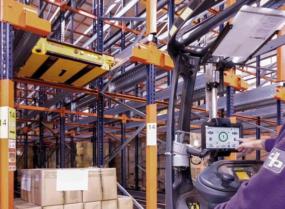 Un operario controla el carro Pallet Shuttle semiautomático desde la carretilla Un operario controla el carro Pallet Shuttle semiautomático desde la carretilla